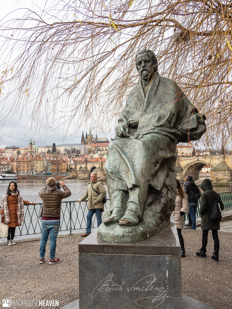 Statue of Czech composer Bedrich Smetana on a platform near Charles Bridge