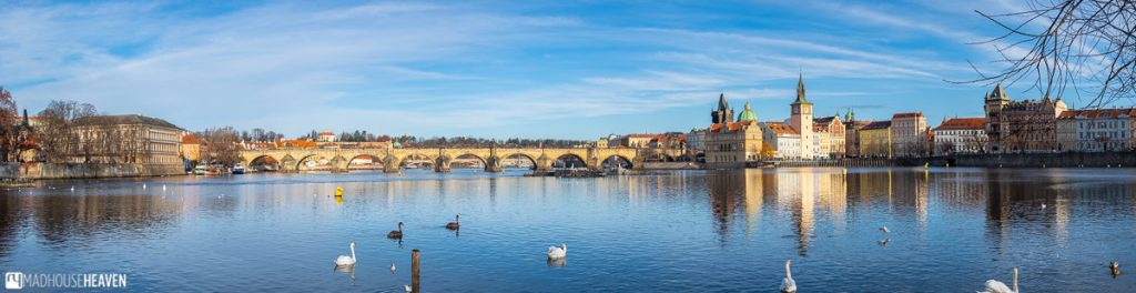Panorama of the Charles Bridge and the Vltava River in Prague on a sunny winter day