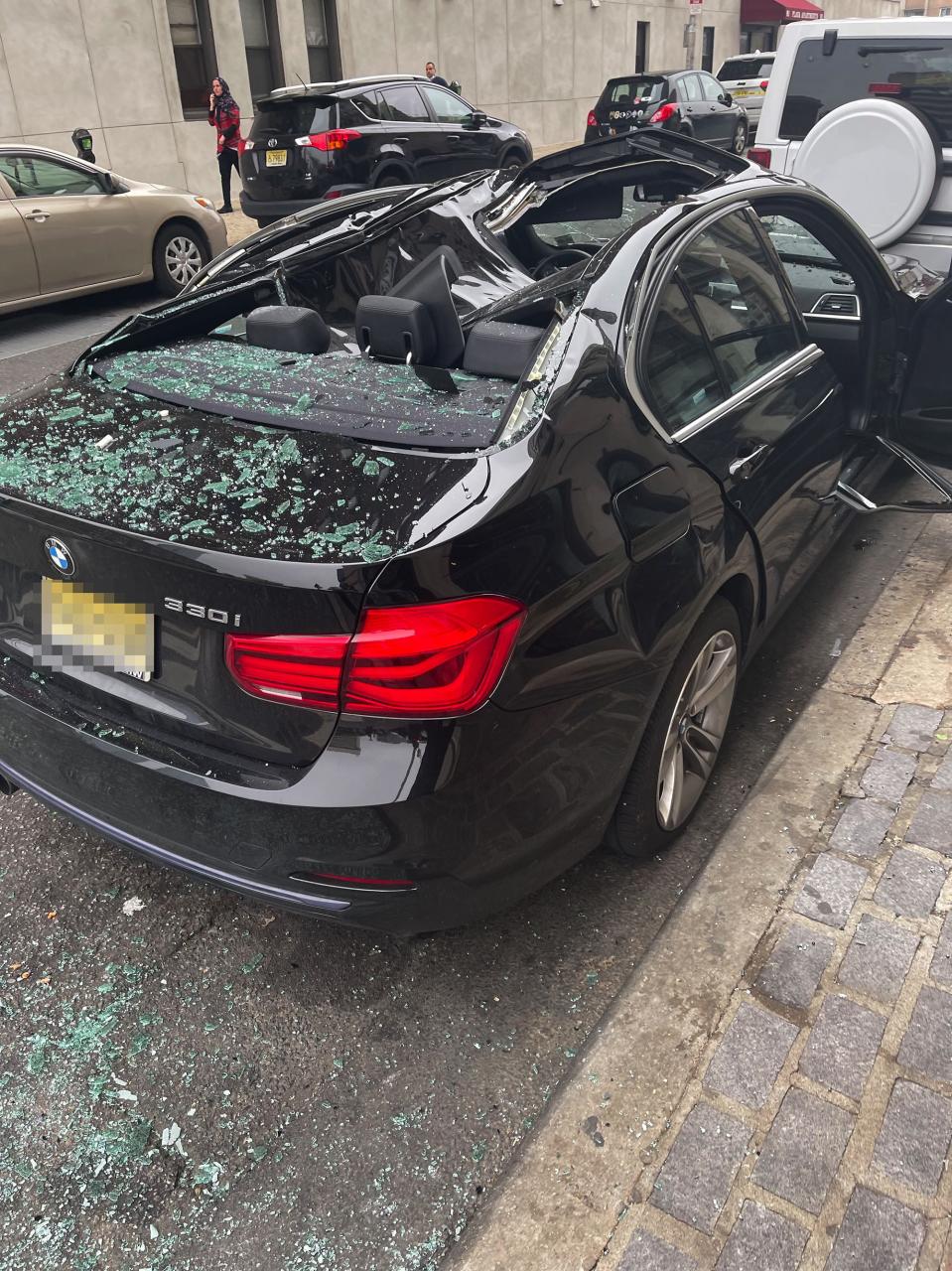 A BMW that broke the fall of a man who fell nine stories in Jersey City.
